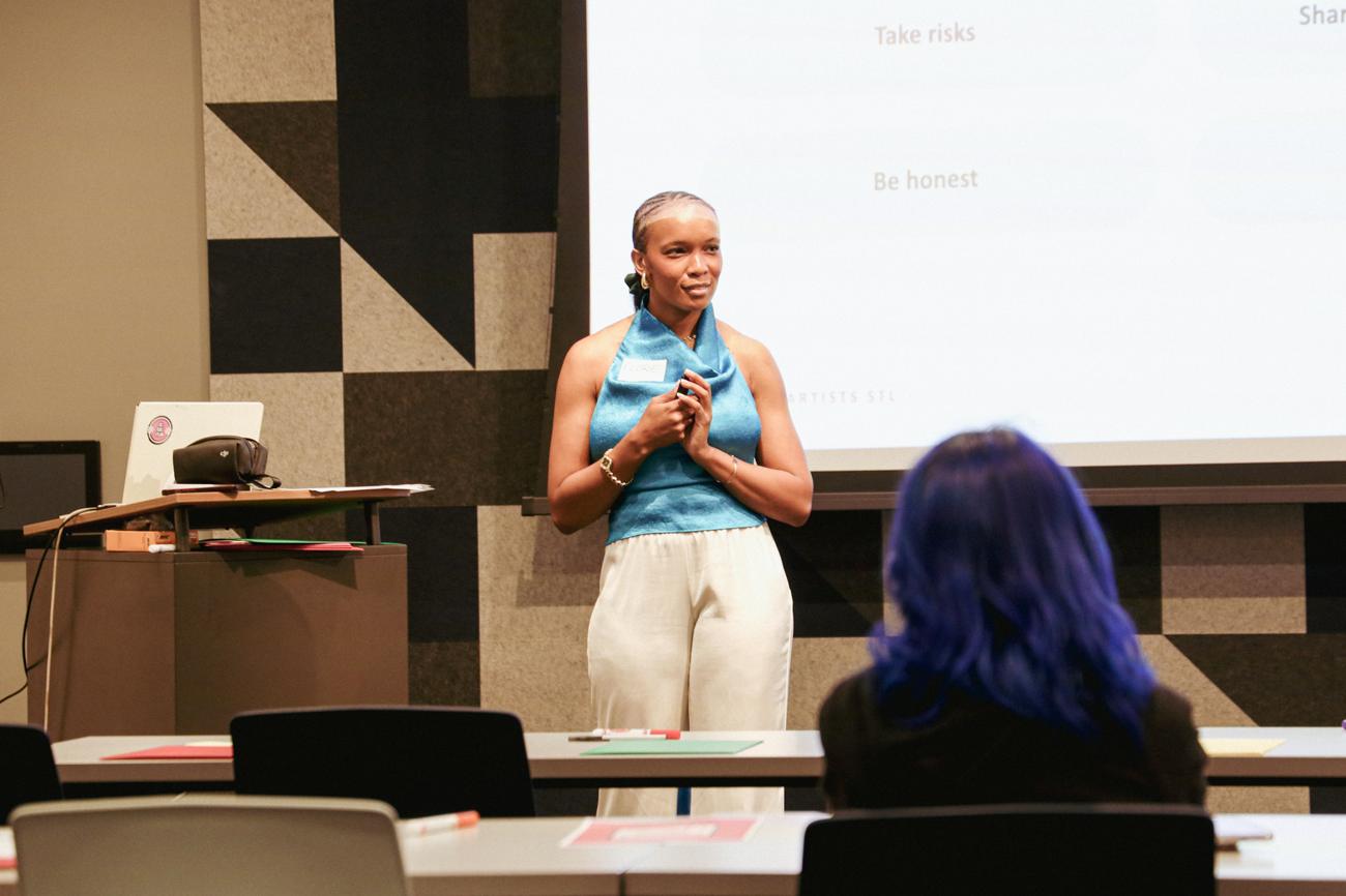 Florie presenting to a room of artists