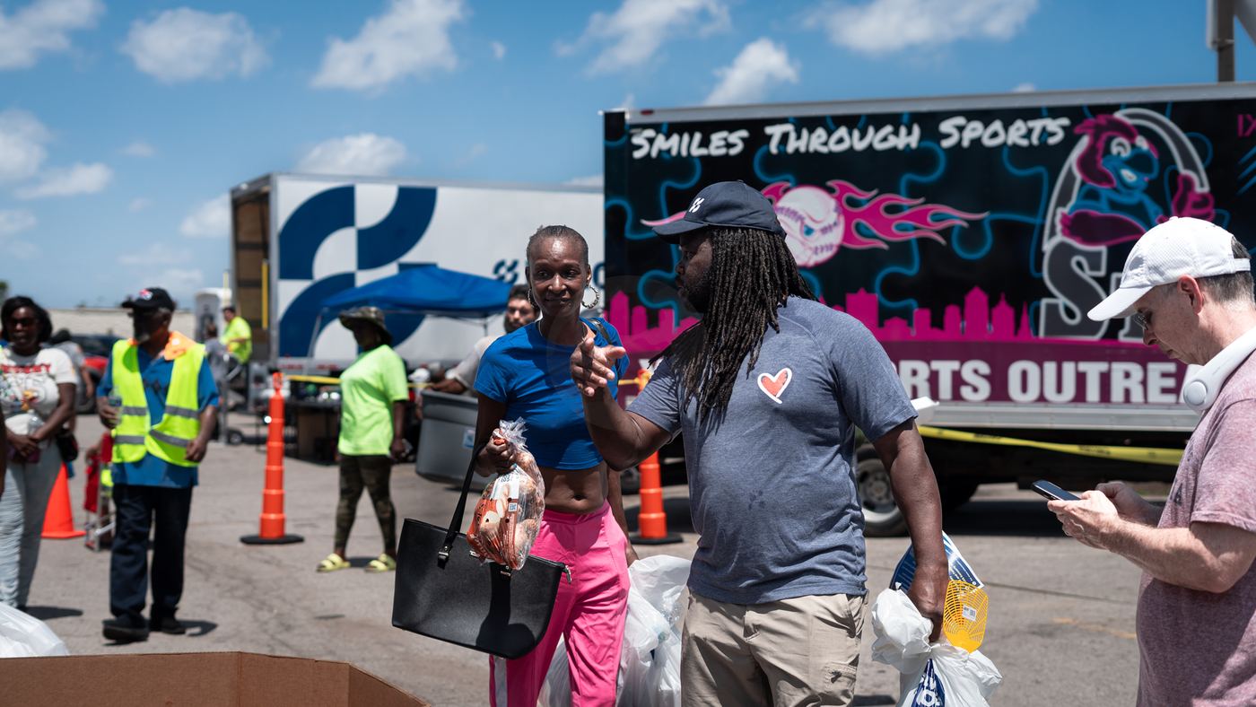 Neighbors collecting supplies near an outreach truck
