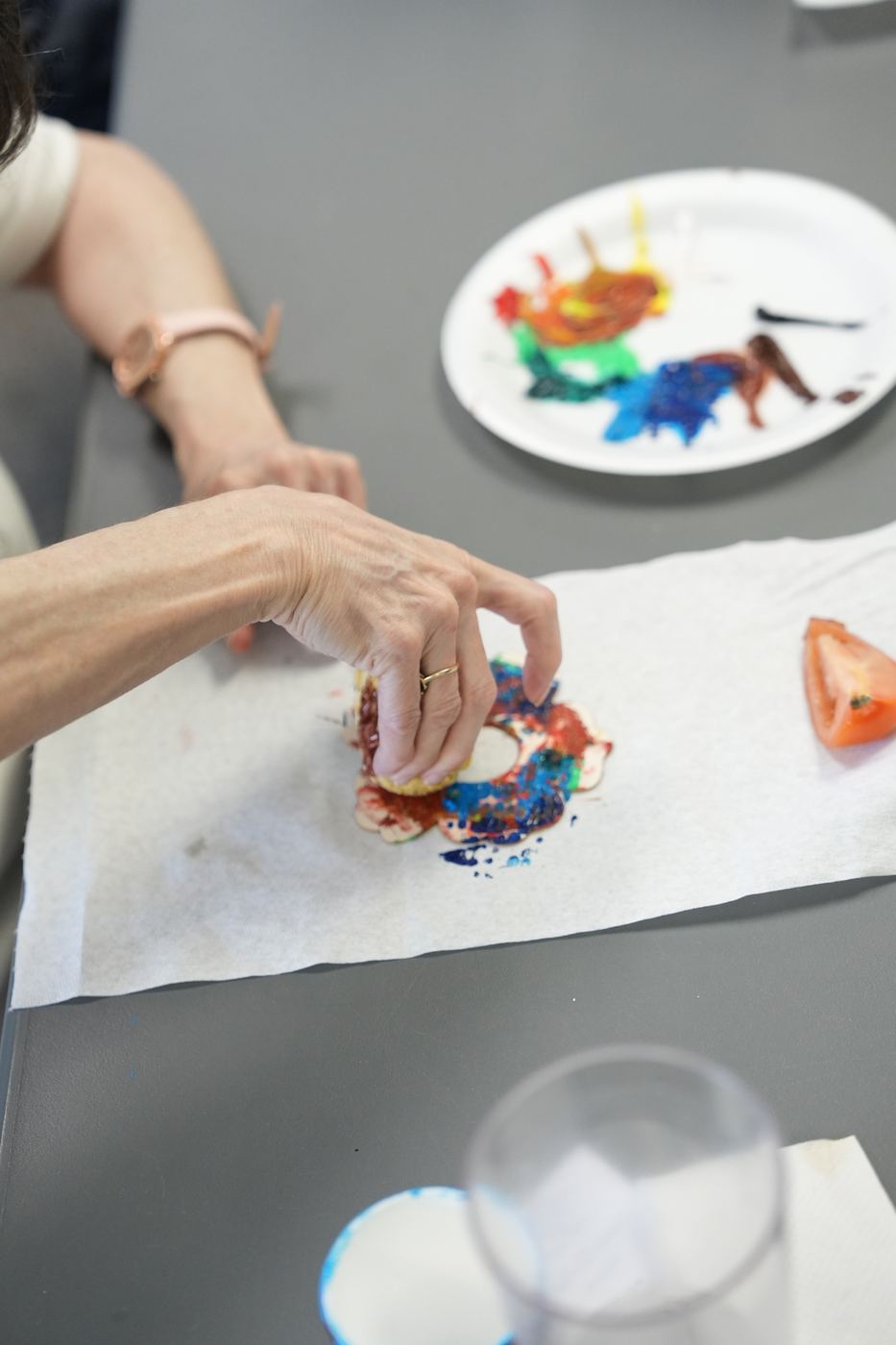 A participant stamping paint with a plantain