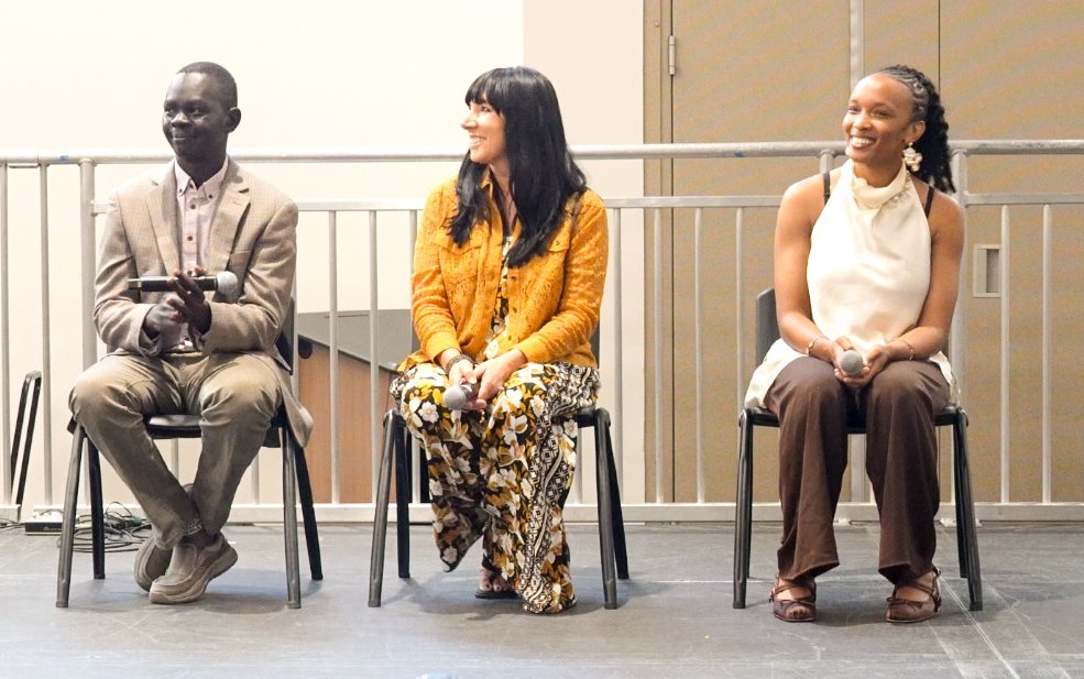 The panelists laughing together on stage