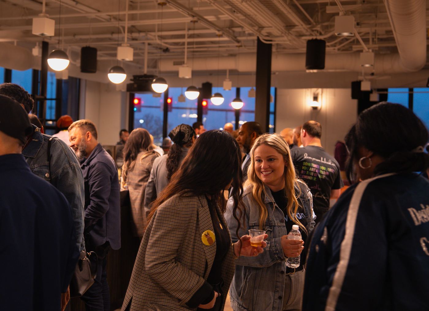 A full room of people mingling